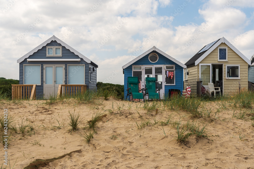 Hengistbury Head, UK - July 1st 2023: Beach huts on Mudeford Sandbank. Hengistbury Head, UK - July 1st 2023: Beach huts on Mudeford Sandbank.