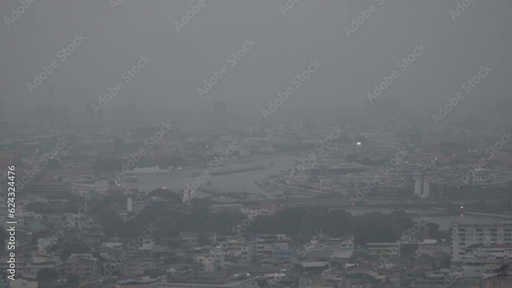 The cityscape of Bangkok is obscured by a thick blanket of dust and