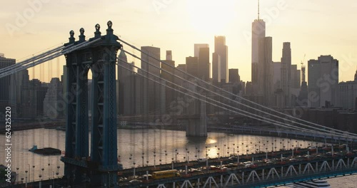 Helicopter Tour of New York City Architecture. Close Up Fly-By Over the Manhattan Bridge. Panoramic View of Office Buildings and Skyscrapers in a Warm Evening Sunlight