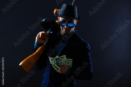 Mature man in sunglasses with gun photo