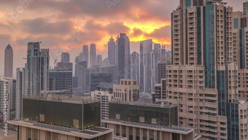 Dubai skyscrapers with golden sunset over business bay district timelapse.