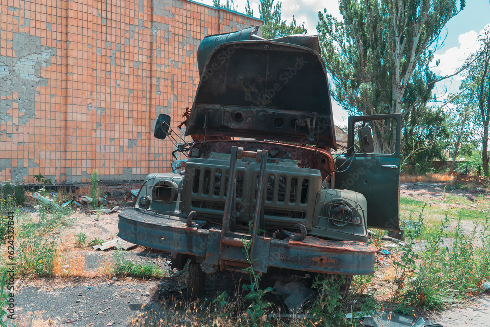A destroyed military truck stands on a city street. War in Ukraine