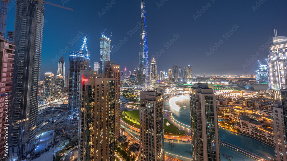 Panorama of Dubai Downtown cityscape with tallest skyscrapers around aerial day to night timelapse.