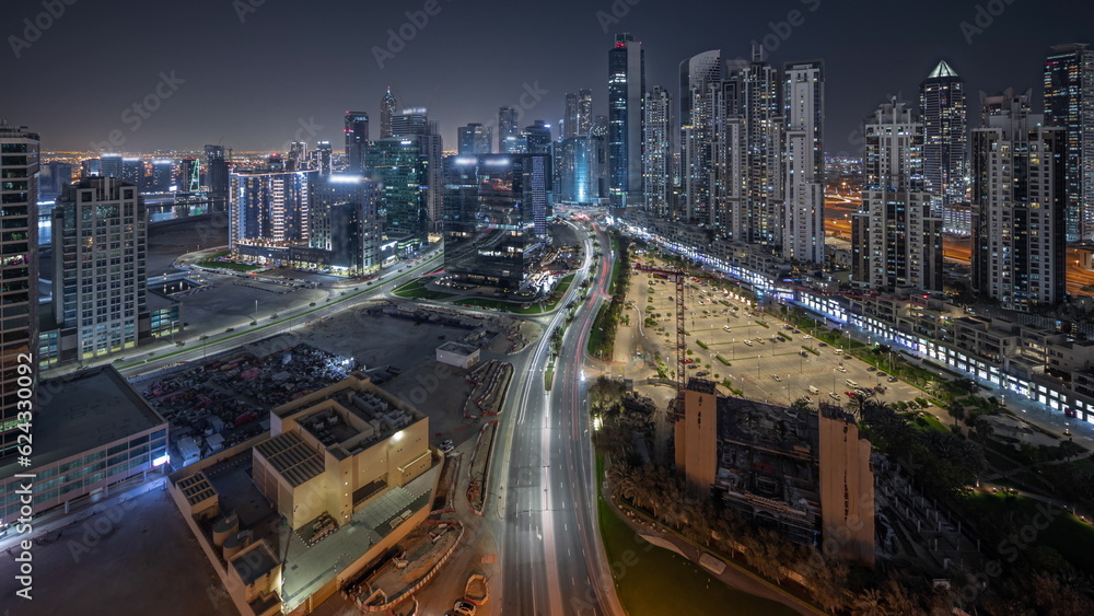 Panorama showing Bay Avenue with modern towers residential development in Business Bay aerial night timelapse, Dubai