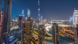 Panorama of Dubai Downtown cityscape with tallest skyscrapers around aerial day to night timelapse.