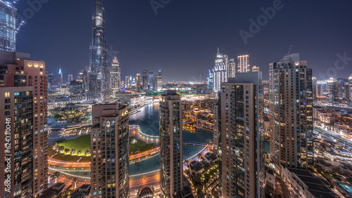 Dubai Downtown cityscape with tallest skyscrapers around aerial day to night timelapse.