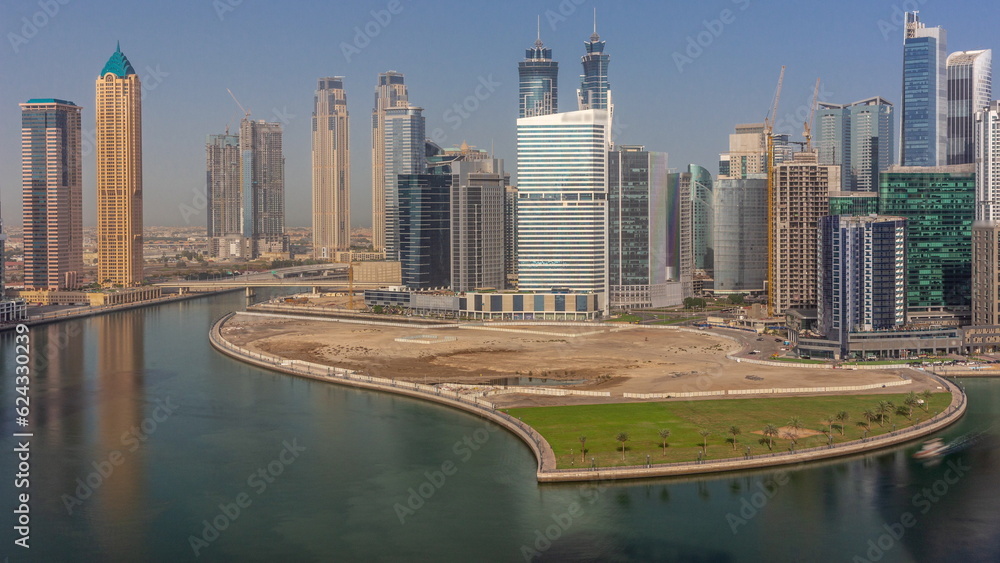 Fototapeta premium Cityscape skyscrapers of Dubai Business Bay with water canal aerial timelapse.