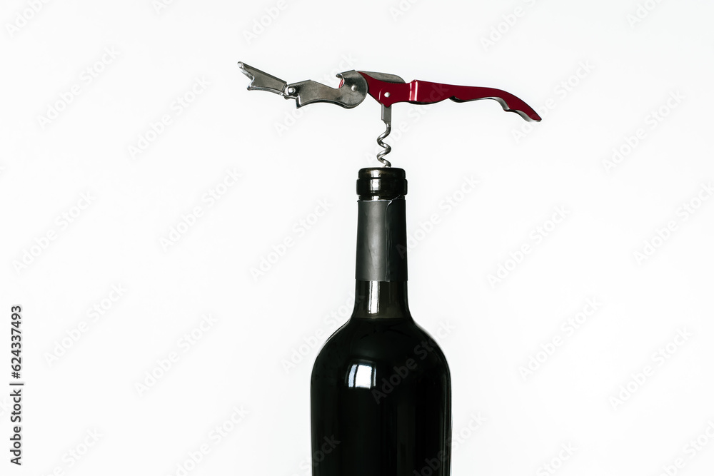 Corkscrew screwed into the cork of a bottle of red wine isolated on a white background Corkscrew screwed into the cork of a bottle of red wine isolated on a white background