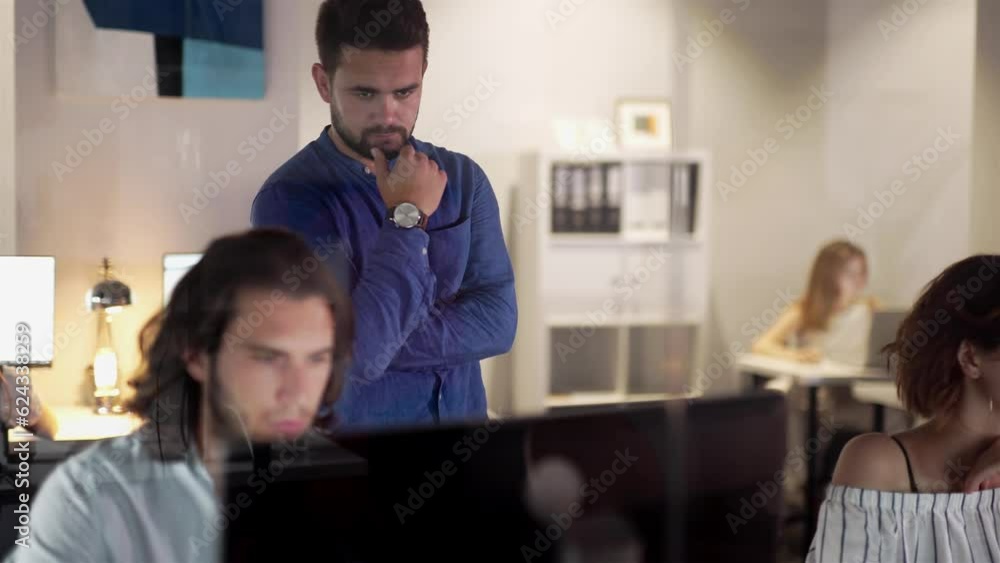 Coworkers looking at a computer and talking about work. Team of colleagues brainstorming together while working on the computer. Men colleagues discuss online project look at pc screen Coworkers looking at a computer and talking about work. Team of colleagues brainstorming together while working on the computer. Men colleagues discuss online project look at pc screen