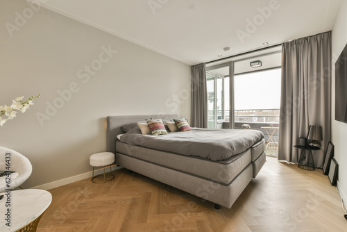 a bedroom with hardwood flooring and large windows looking out onto the cityscapearrons com uk