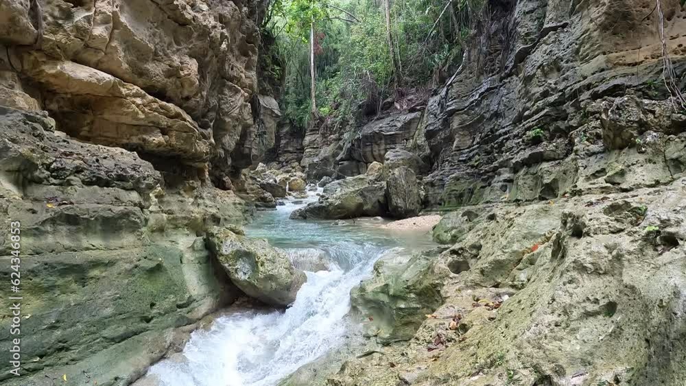Deep natural gorge with fresh river stream flowing in bottom - Static slow motion aerial Philippines Deep natural gorge with fresh river stream flowing in bottom - Static slow motion aerial Philippines