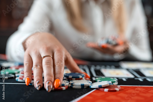 beautiful young woman plays poker in casino