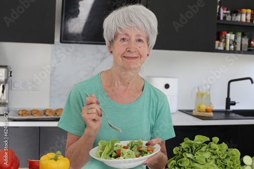 Senior woman enjoying a very healthy vegan salad 