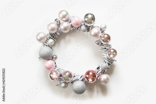 Christmas white wreath of silver and pink balls, painted vine on white background.