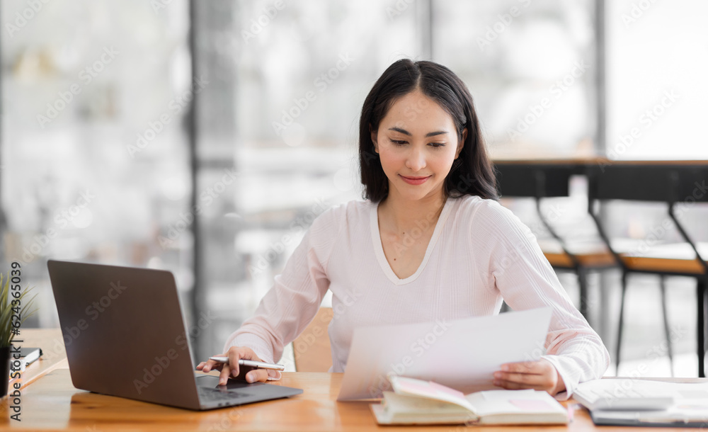 Young asian woman using laptop computer for business studying, watch online virtual webinar training meeting, video call. Focused asian woman or Latin business woman work in office, copy space. Young asian woman using laptop computer for business studying, watch online virtual webinar training meeting, video call. Focused asian woman or Latin business woman work in office, copy space.