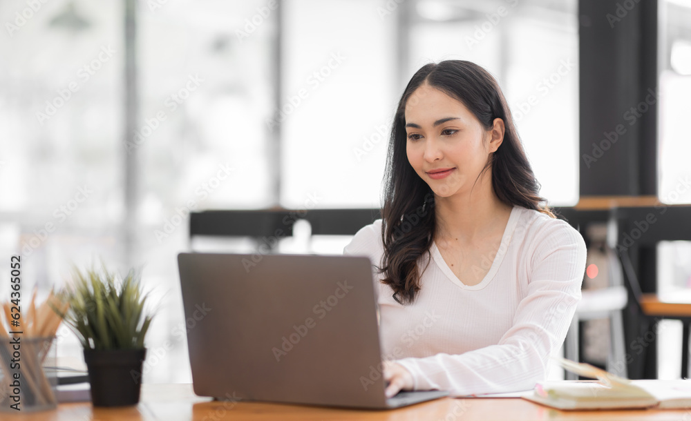 Young asian woman using laptop computer for business studying, watch online virtual webinar training meeting, video call. Focused asian woman or Latin business woman work in office, copy space. Young asian woman using laptop computer for business studying, watch online virtual webinar training meeting, video call. Focused asian woman or Latin business woman work in office, copy space.