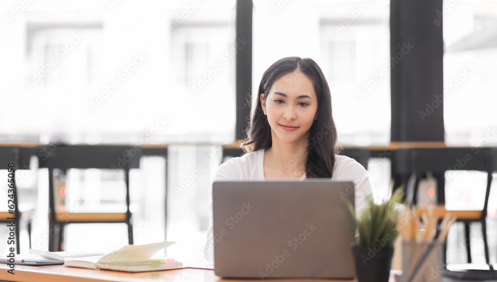 Young asian woman using laptop computer for business studying, watch online virtual webinar training meeting, video call. Focused asian woman or Latin business woman work in office, copy space. Young asian woman using laptop computer for business studying, watch online virtual webinar training meeting, video call. Focused asian woman or Latin business woman work in office, copy space.