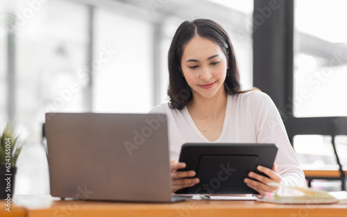 Young asian woman using laptop computer for business studying, watch online virtual webinar training meeting, video call. Focused asian woman or Latin business woman work in office, copy space. 