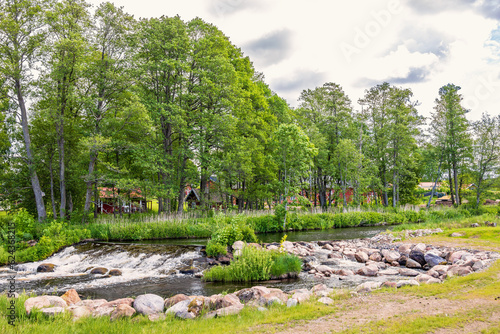 Stream in a rural landscape by a tree grove photo