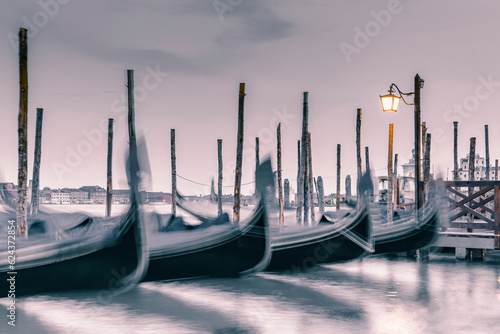 Picture with gondolas moored on Grand Canal near Saint Mark square, in Venice Italy.