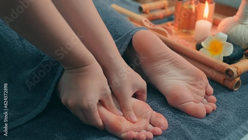 Close up view of female hands doing foot massage on procedure in spa salon