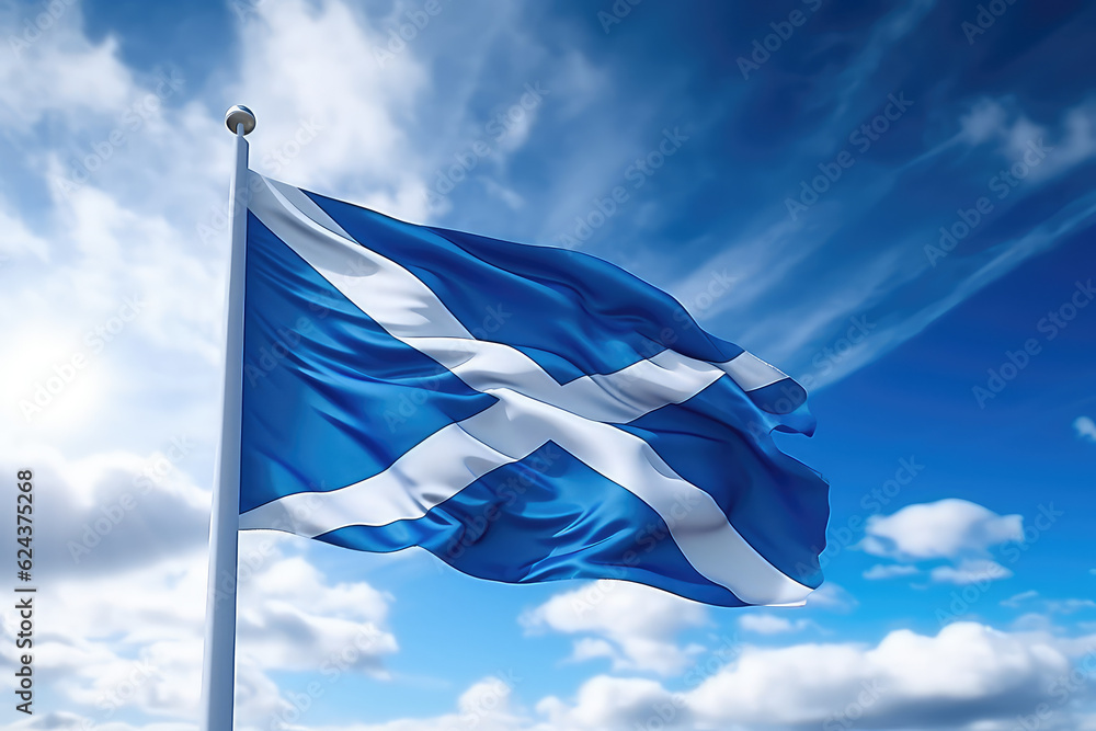 Scottish flag flying in the wind on a flagpole against a blue sky with