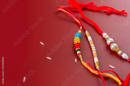 Raksha Bandhan background. Rakhi bracelets and rice grains. Traditional Indian Holiday Festival