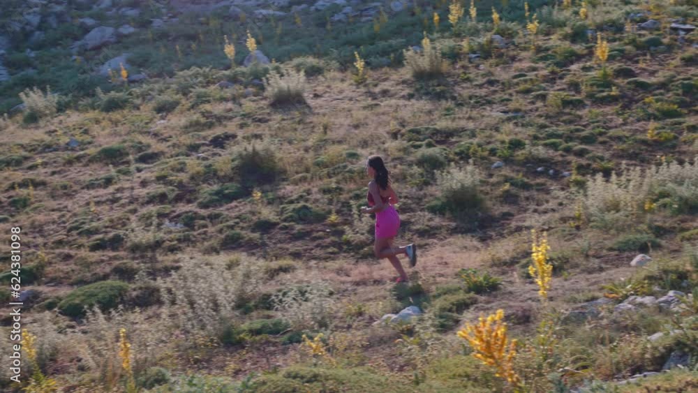 Woman runner running in slow motion. mountain run. skyrunning. healthy lifestyle and fitness concept. Woman runner running in slow motion. mountain run. skyrunning. healthy lifestyle and fitness concept.