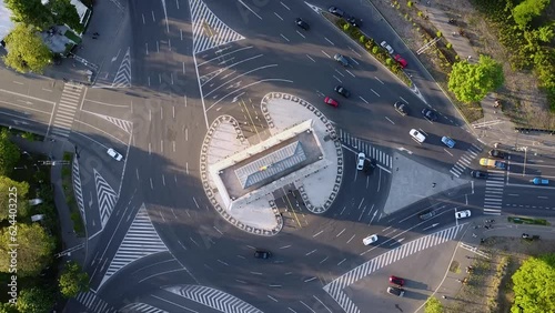 4K Top Down aerial Drone view of cars driving around a picturesque roundabout in Eastern Europe. Arcul de Triumf Bucuresti. The Triumfal Arch Bucharest. photo