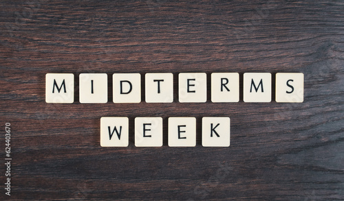 Photos Back to school concept. Finals week word on wooden desk.