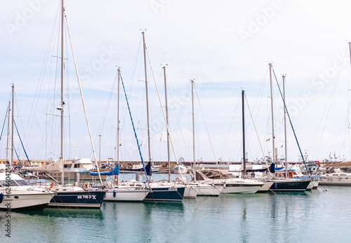 Front view, far distance of, a  row of, tall, sailing ships, moored, at an Italian harbor, on Adriatic coastline © reve15