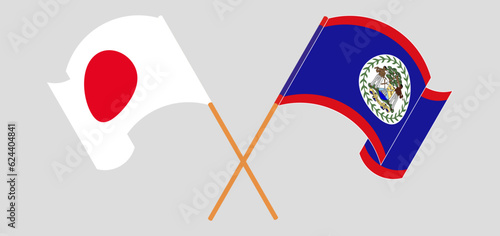 Crossed and waving flags of Japan and Belize