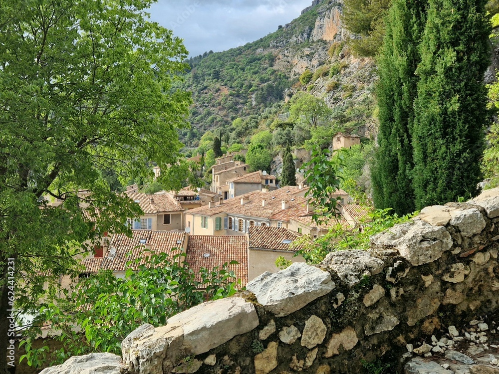
View of historic Moustiers-Sainte Marie, village in Provence near Gorge du Verdon with steps up to church on hilltop