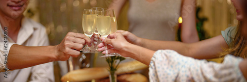 Group of friends celebrating with champagne  Close up on hands.