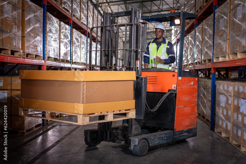 Africa worker industry factory wear safety uniform factory drive forklift truck moving goods boxes to industry production in factory warehouse area is industry manufacturing transportation concept.