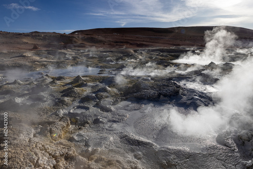 Fototapeta Naklejka Na Ścianę i Meble -  Stunning geothermic field of Sol de Mañana with its steaming geysers and hot pools with bubbling mud - just one sight on the lagoon route in Bolivia, South America