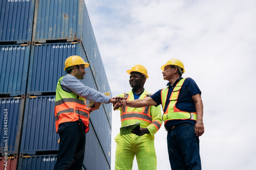 Team worker stack hand and shake hands to show success work at Container cargo harbor. Logistics concept inside the shipping, import, and export industries. . Team worker stack hand and shake hands to show success work at Container cargo harbor. Logistics concept inside the shipping, import, and export industries. .