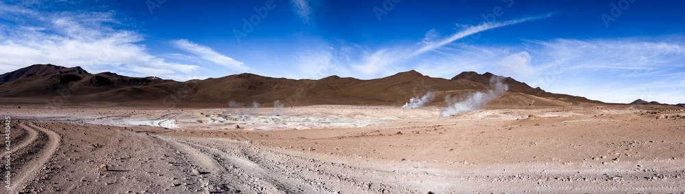 Stunning geothermic field of Sol de Mañana with its steaming geysers and hot pools with bubbling mud - just one sight on the lagoon route in Bolivia, South America - Panorama