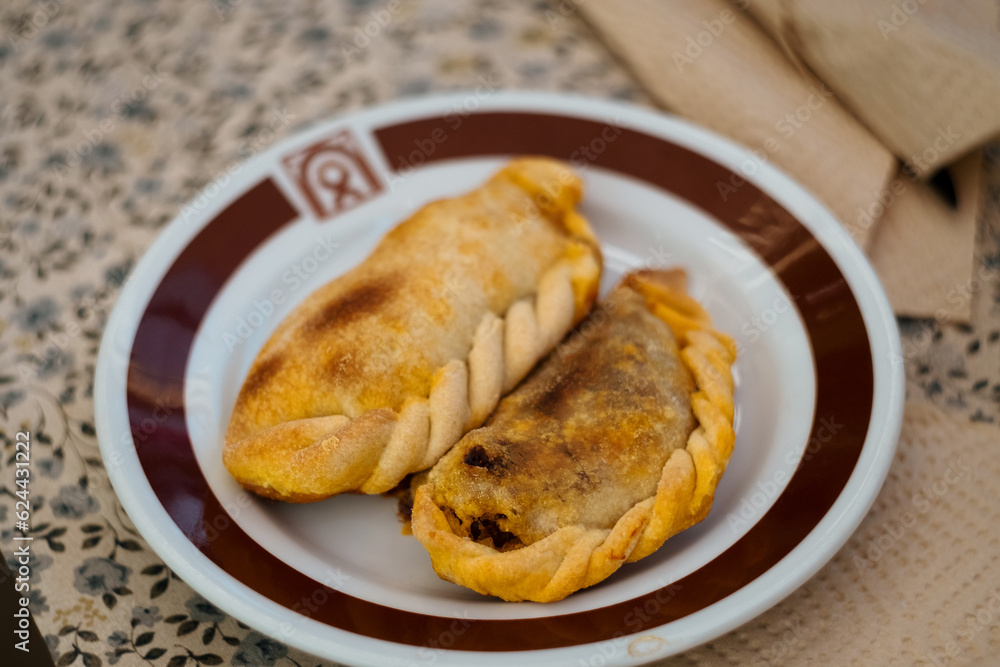 traditional Argentinean empanadas filled with beef, onions, paprika, hot pepper powder, cumin, oregano, hard-boiled egg and olives traditional Argentinean empanadas filled with beef, onions, paprika, hot pepper powder, cumin, oregano, hard-boiled egg and olives