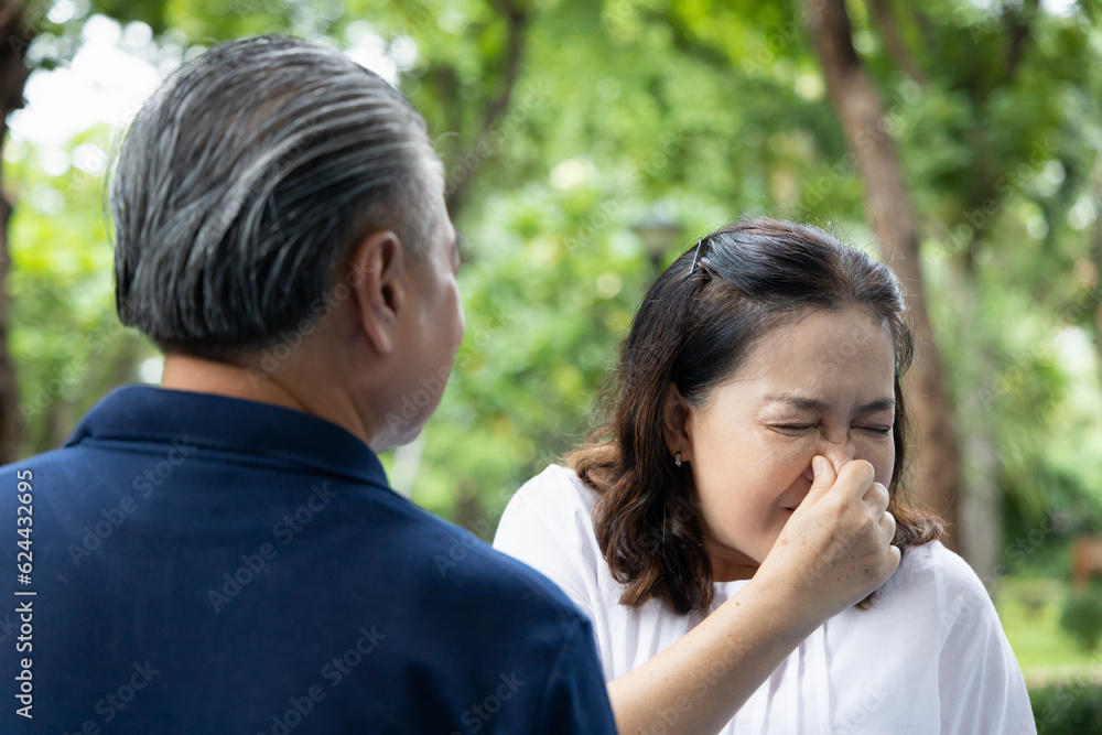 Senior Asian Man with Bad Breath, Unpleasant Mouth Smell and oral care Concept Senior Asian Man with Bad Breath, Unpleasant Mouth Smell and oral care Concept