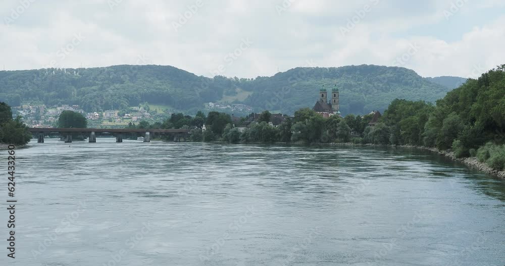 Bad Saeckingen district of Waldshut. View of the covered wooden bridge and St.Fridolin Gothic Cathedral in the middle of the town along the river Rhine Bad Saeckingen district of Waldshut. View of the covered wooden bridge and St.Fridolin Gothic Cathedral in the middle of the town along the river Rhine