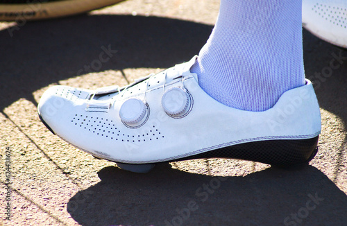 DETAIL OF A CYCLIST SHOE on asphalt, ready to use