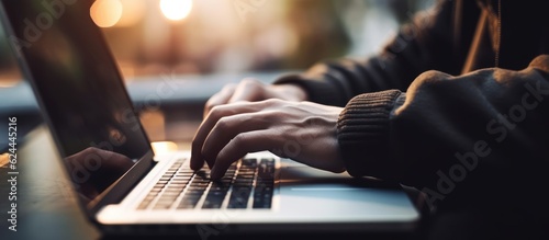 Young man hand working on a laptop, bokeh blurred white background at For text copy space. AI Generative © Tisha