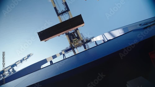 4K footage from right underneath port crane stock video. Crane lifting and placing cargo container stock video.