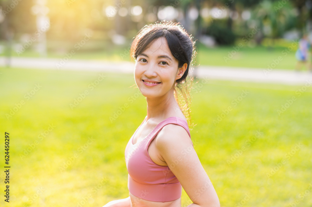 Capture the essence of wellness living with a happy, young 30s Asian woman smiling at the camera in a park at sunset. Embrace the beauty of wellness. Capture the essence of wellness living with a happy, young 30s Asian woman smiling at the camera in a park at sunset. Embrace the beauty of wellness.