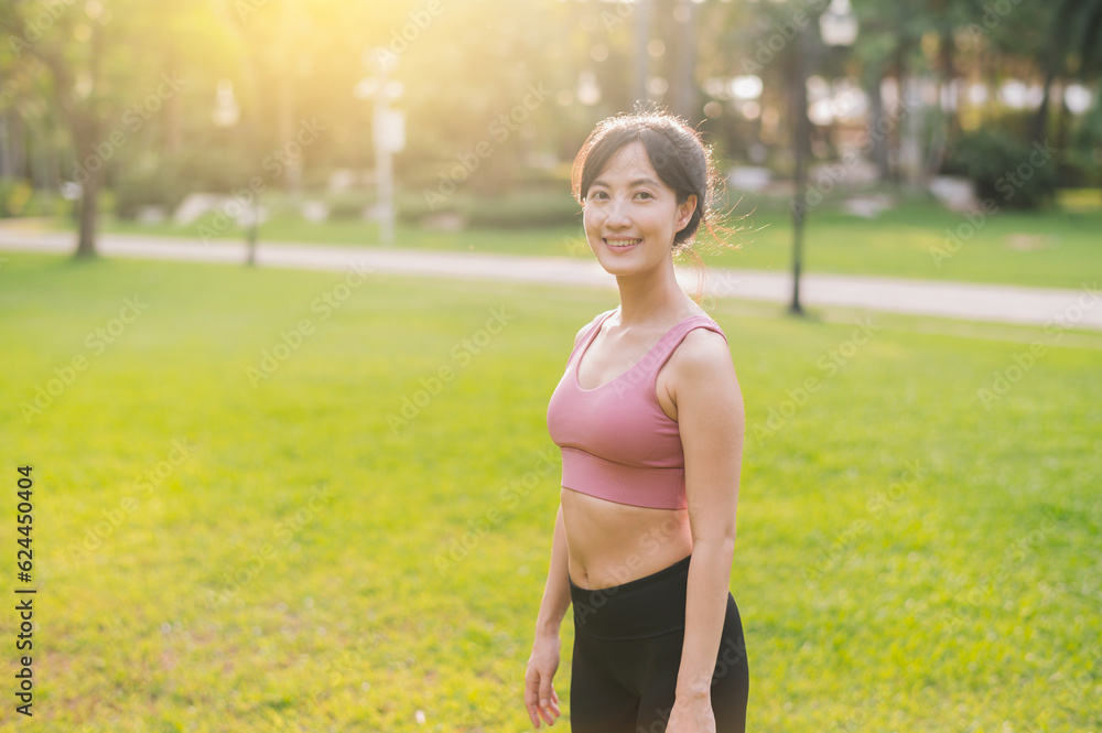 Experience the joy of a happy, fit female jogger in her 30s. Asian woman wearing pink sportswear, enjoying fresh air in a public park. Embrace wellness living and connect with nature. Experience the joy of a happy, fit female jogger in her 30s. Asian woman wearing pink sportswear, enjoying fresh air in a public park. Embrace wellness living and connect with nature.