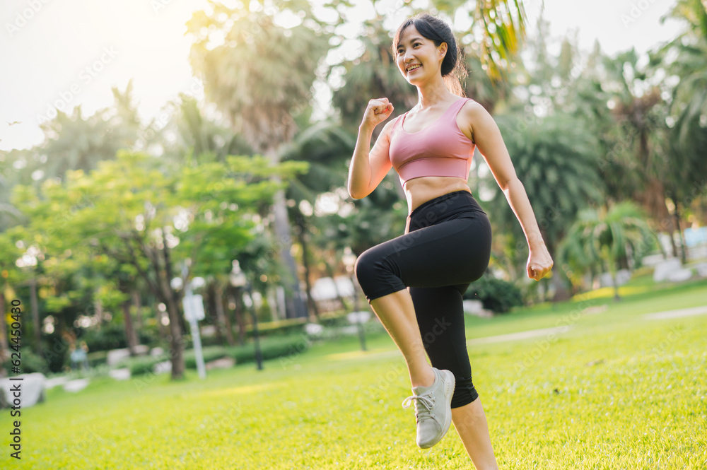 Immerse yourself in concept of wellness and well-being. fit Asian woman in 30s, wearing pink sportswear, exercising in public park at sunset. inspiring display of a healthy outdoor lifestyle.