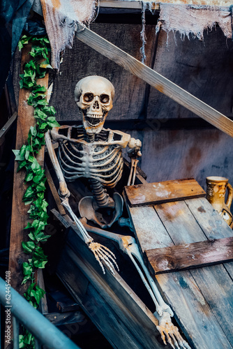 Outdoor Decor for Halloween. skeletons climbing out of the different wooden rubble. Halloween scenery. Terrible holiday photo zone on location for event. Traditions and decorations. Selective focus