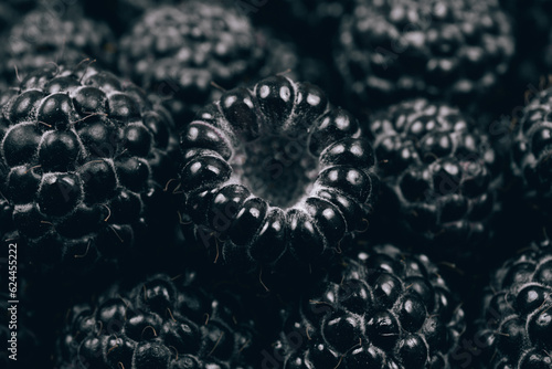 Black raspberries closeup. Macro shot. Heap of fresh ripe and sweet raspberries. 