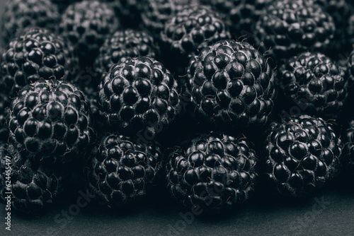Black raspberries closeup. Macro shot. Heap of fresh ripe and sweet raspberries. 